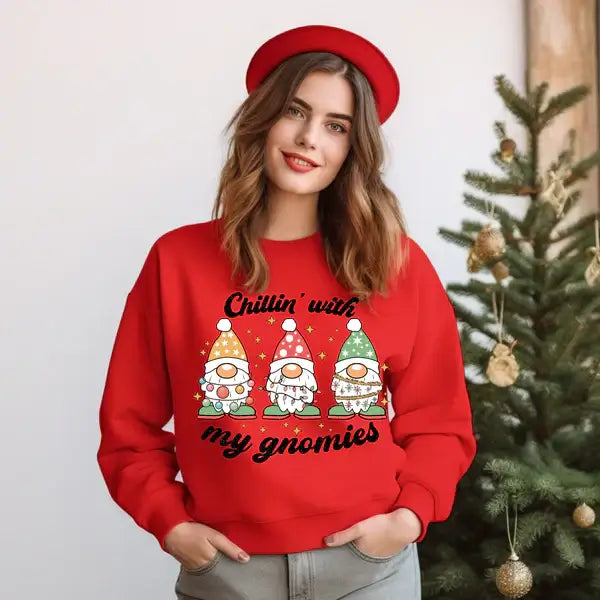 Woman in a red sweatshirt with "Chillin' with my gnomies" design, festive background with Christmas decor.